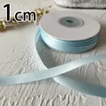 Detail of 1cm light blue double-sided satin ribbon roll with smooth glossy texture - Light Blue