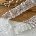 White polka dot pleated mesh lace trim for DIY sewing and clothing decoration on wood surface - Length 1m Width 4cm approx / White