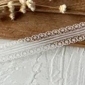 Intricate white eyelash lace ribbon with hollow floral design for DIY sewing and crafts - Style Fifteen Off White Slim