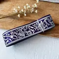 Deep purple ribbon with silver Halloween patterns on rustic wooden background - Magic Purple