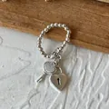 Elegant silver beaded ring featuring a heart lock and heart key charm set on white - Heart Lock Key Bead Charm / Silver