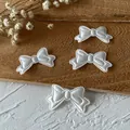 Set of 4 white satin bow patches with pearl edge for DIY crafts and sewing projects - White Bow Patch