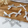 Set handgefertigter silbergrauer Satinbandschleifen für DIY-Haarschmuck und Dekorationen - Mini-Schleifenhalskette / 10 Stück/Packung (Bandbreite 0,6 cm) / Hellgrau