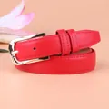 Women's red PU leather belt with triple hollow heart gold buckle on pink background - Red