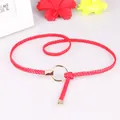 Slim handmade woven red belt for women featuring a gold round buckle and polished metal tip - Red