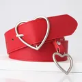 Vibrant red faux leather belt featuring a silver heart buckle and matching pendant charm - Red