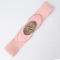 Women's pink elastic wide waist belt featuring a vintage bronze hollow floral buckle - Pink