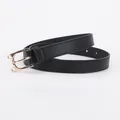 Slim black leather belt for women featuring a golden cat-shaped metal buckle design - Black