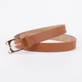 Women's slim brown leather belt featuring a golden cat-shaped geometric buckle - Camel