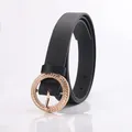 Classic black leather belt for women with a textured golden round buckle and pin closure - Black