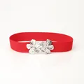 Elastic red waist belt for women featuring a polished silver metallic flower buckle - Red