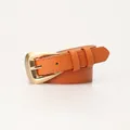 Minimalist orange-brown leather belt with polished gold curved buckle for women - Camel
