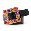 Women stylish black leather belt featuring oversized gold buckle with multi-color rhinestones - Black