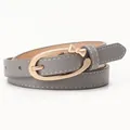 Slim grey PU leather belt for women with a gold bow buckle and white stitching details - Gray