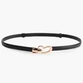 Women's black faux leather waist belt featuring a polished golden heart-shaped metal buckle - Black