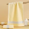 Pale yellow thick cotton face towel with gray stripes in a cozy bathroom setting - 74cm x 34cm / Yellow (Arrow Pattern)