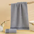 Absorbent gray cotton towel featuring a modern geometric meander border design - Gray / 74x34cm