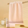 Peach pink soft cotton face towel with brown striped hem on a wooden branch - 75x35cm / Lotus root pink