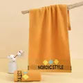Absorbent ginger yellow cotton face towel with Nordic Style embroidery on wooden rack - 75*35cm / Rhombus Orange