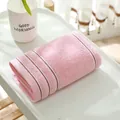 Soft pink cotton towel with brown stripes neatly folded on a white ceramic tray - 74cmx34cm / Pink