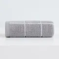 Thick grey cotton face towel rolled up showing soft absorbent texture and ribbed details - Gray