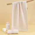 Plush beige cotton face towel set with dense loop texture on a wooden hanger - 74*34cm / Light Coffee