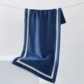 Thick navy blue coral fleece towel with cream edges hanging on a minimal rope display - 40x80cm / Navy Blue