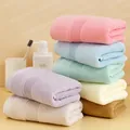 Thick cotton towel set in various pastel colors stacked in a tidy bathroom setting - 74*34cm / Multicolor