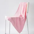 Soft pink pure cotton towel with geometric jacquard pattern on a white chair - 100cm x 50cm / Sakura Pink