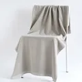 Thick light gray cotton bath towel with dense loop texture draped over a modern chair - Plain Weave / Gray