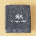 Thick charcoal grey cotton towel featuring white bull embroidery and Ox patient text - Ox(Ox patient) / Face Towel (75x35cm) / Gray