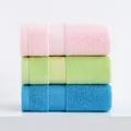 Three-pack cotton towels in pink green and blue with textured herringbone jacquard pattern - 34x74cm / Pink and Green and Blue