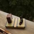 Miniature black cat figurine lying on tatami base with retro TV phone holder stand - Black Cat Tatami