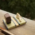 Japanese style miniature calico cat figurine on green tatami mat with a small brown cabinet - Calico Cat Tatami