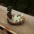 Japanese style miniature resin cat figurine on hot spring base phone holder stand - Calico Cat Hot Spring