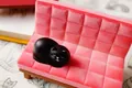 Cute black cat phone stand on a miniature pink velvet sofa with embossed texture - Black Cat
