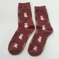 Retro deep red crew socks with white cat silhouette patterns and colorful speckles - One Size / Rust Red