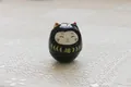 Miniature black ceramic Daruma Lucky Cat figurine with golden Fuku kanji character - Black