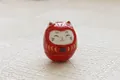 Japanese ceramic Daruma fortune cat ornament in bright red with lucky Fu character - Red