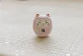 Pink ceramic Daruma Maneki Neko figurine with black Fu character on round body - Pink