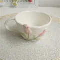 Handmade cream ceramic tulip coffee mug with pink floral relief and wavy rim - Mug / Pink
