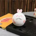 Japanese style hand-painted ceramic rabbit tumbler figurine with pink floral details - Lucky Rabbit
