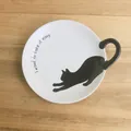 White ceramic cat plate with a black kitty tail handle and casual quote - Dish