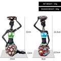 Set of two resin African figurine candle holders in green and blue floral dresses - Green And Blue Top Combination Style