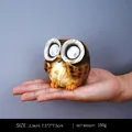 Solar owl ornament with LED glowing eyes in a handheld scale for outdoor decor - Style B