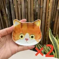 Set of 2 cute ginger tabby cat face ceramic sauce dishes held in hand for scale - Orange Tabby Cat
