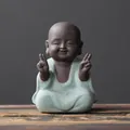 Zen little monk ceramic tea pet in light green robe with a peaceful smiling expression - Alms Giving