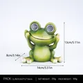 Solar powered green frog garden ornament with size 14x13x8cm and glowing eyes - Hear No Evil