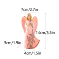 Pink praying angel resin figurine with carved floral details and product dimensions - Pink