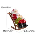 Figura de resina de Papá Noel en silla mecedora con pergamino de lista de regalos - Papá Noel En Mecedora Escribiendo Lista